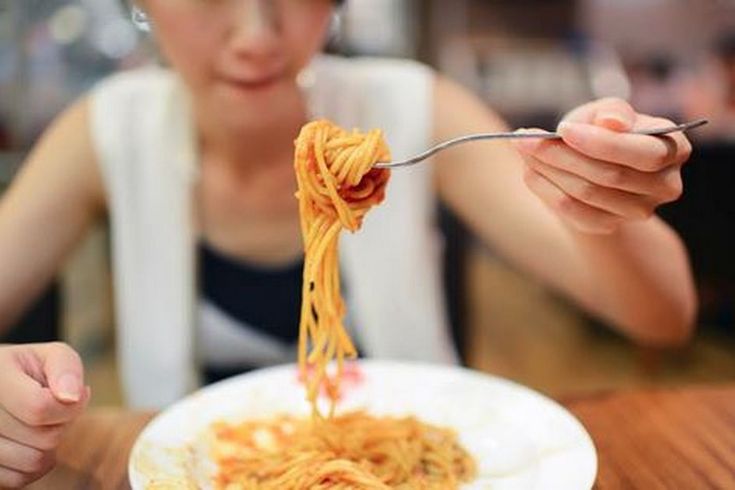 woman eating pasta