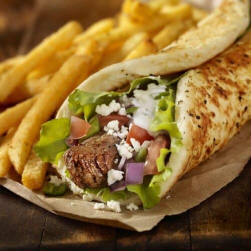 Beef Souvlaki Pita Wrap with Lettuce, Tomatoes, Red Onions, Feta Cheese, Tzatziki Sauce and a Side of french Fries