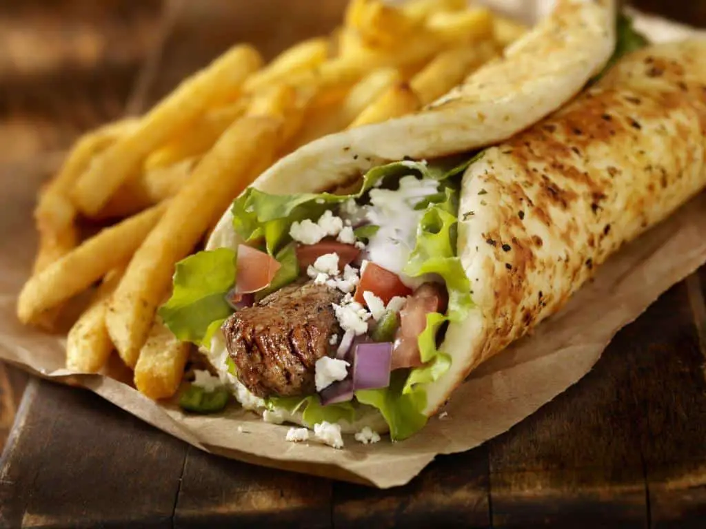 Beef Souvlaki Pita Wrap with Lettuce, Tomatoes, Red Onions, Feta Cheese, Tzatziki Sauce and a Side of french Fries