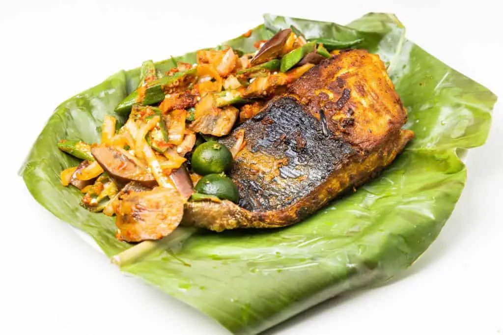 Grilled Stingray Fish With Spices and Vegetable Served on Banana Leaf ...