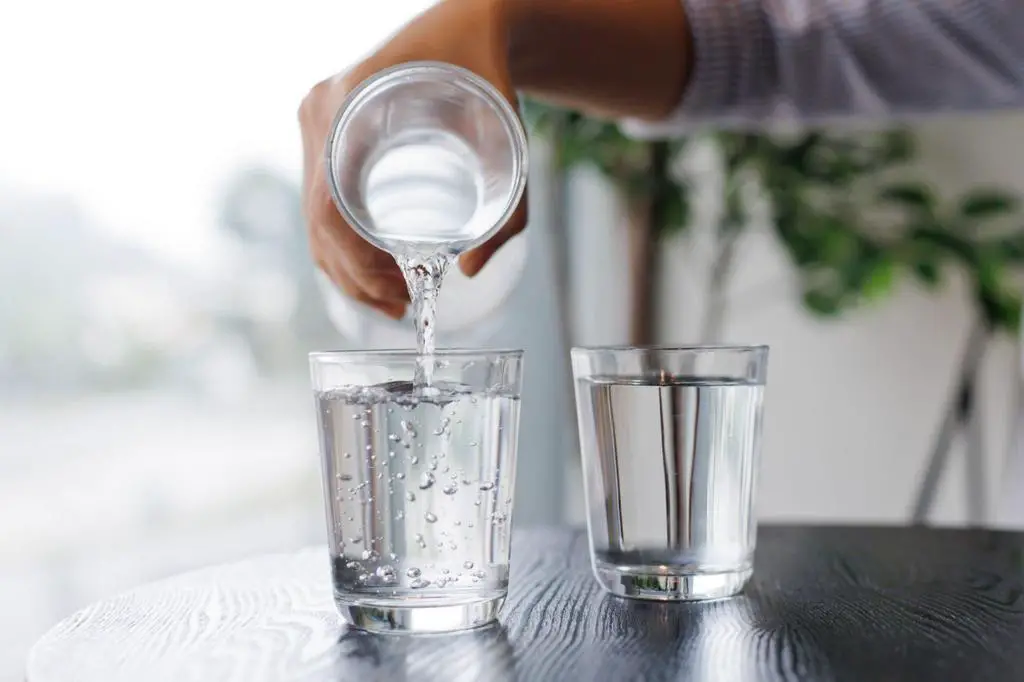 mineral water from bottle into the glass