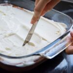 applying a layer of whipped cheese cream