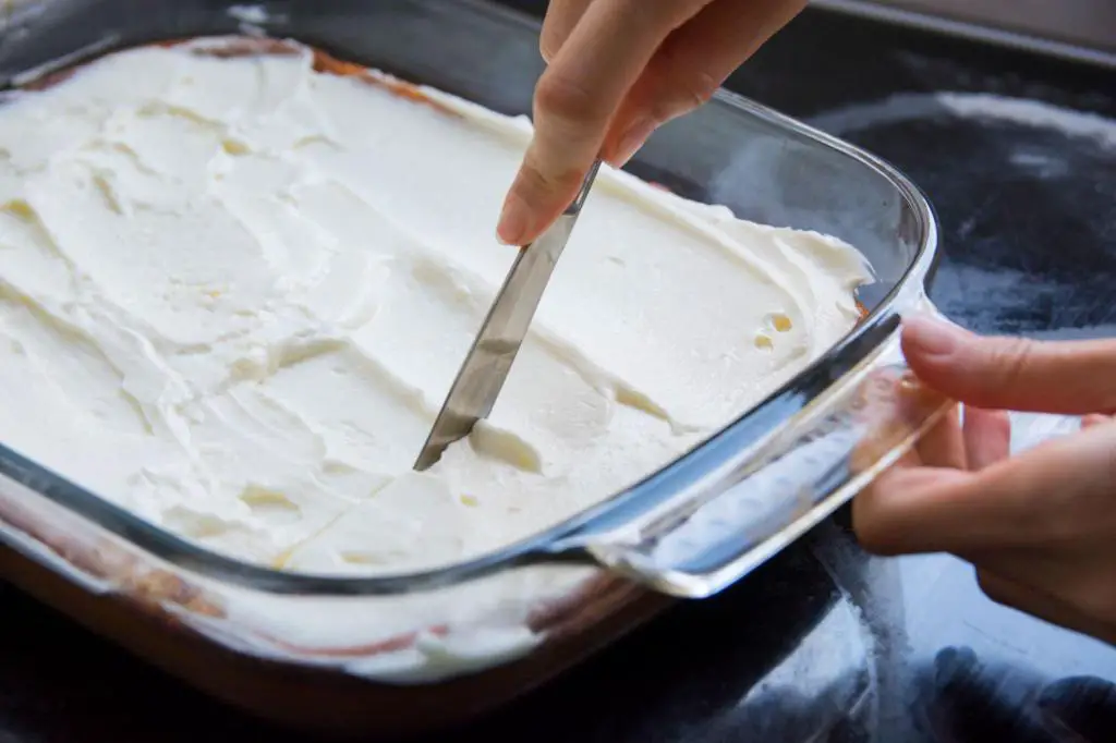 applying a layer of whipped cheese cream