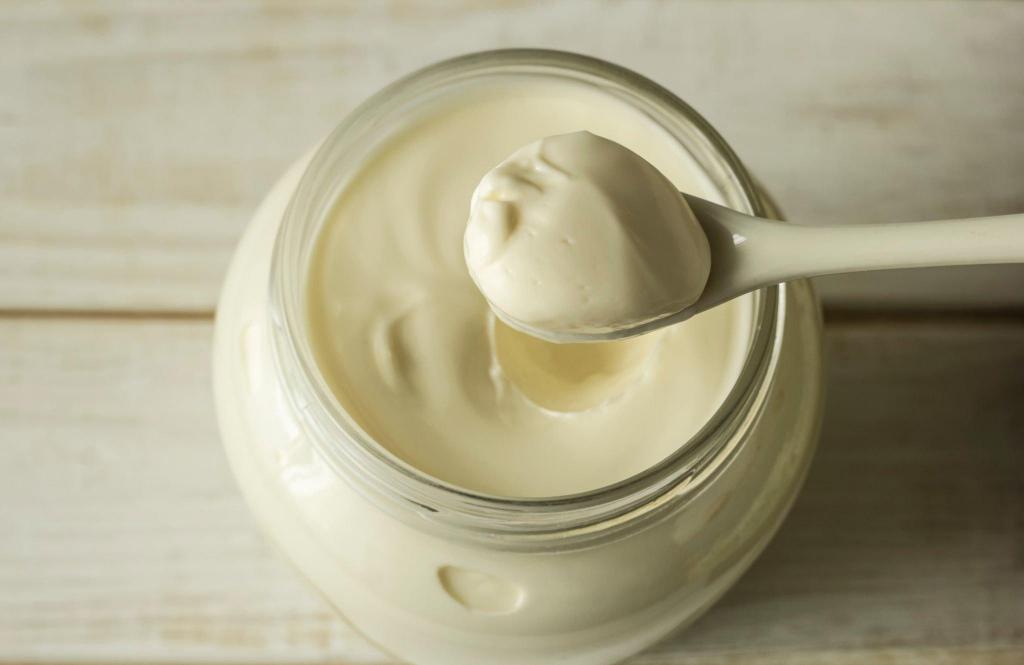mayonnaise in a glass jar with-a-spoon