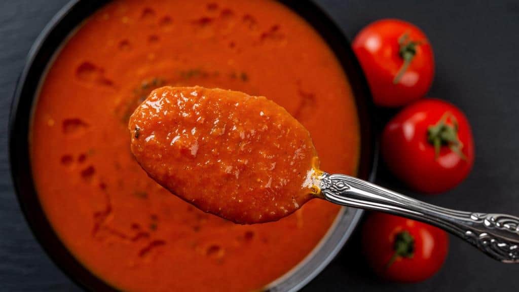 hot tomato soup over bowl