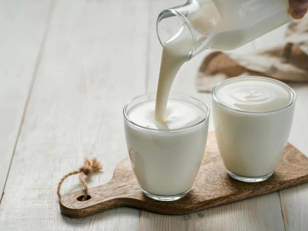 pouring homemade kefir buttermilk yogurt