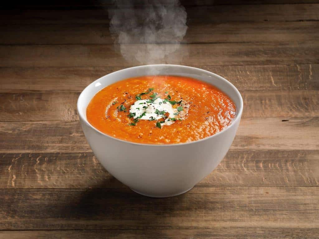 tomato soup ready to eat on wooden table