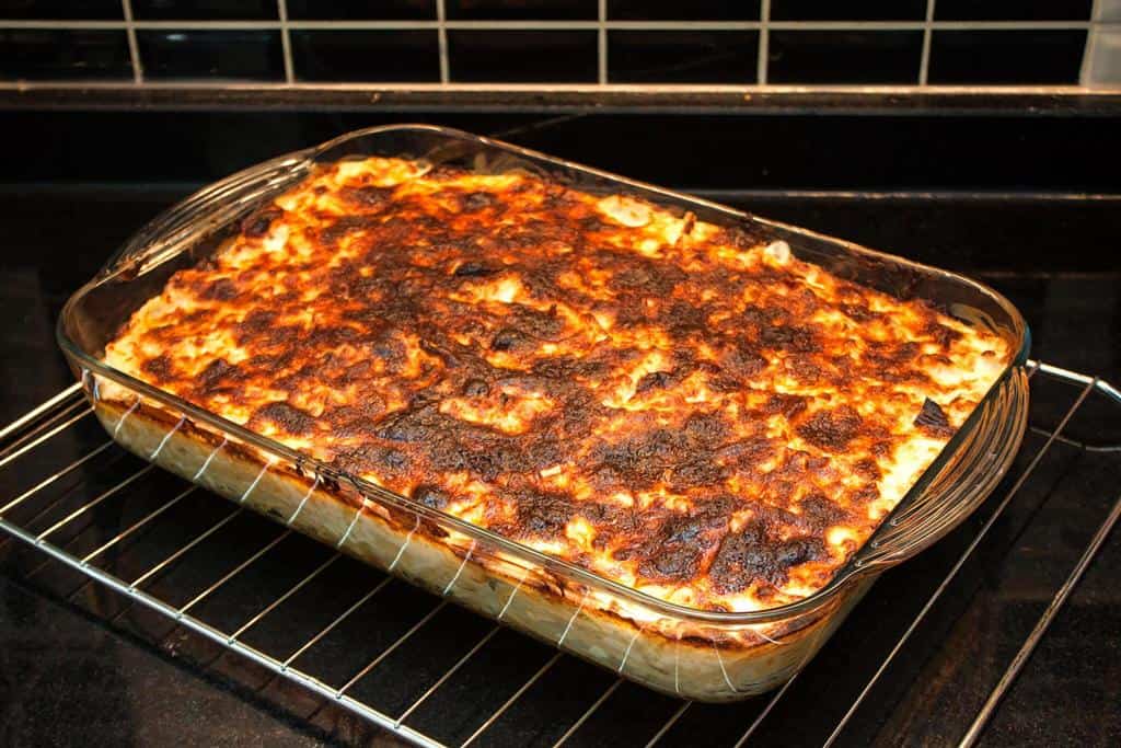 baked pasta bake with melted cheese in pyrex glass