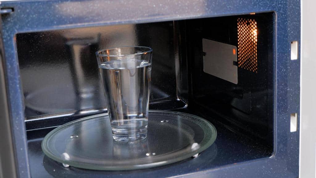 a glass of water heating in microwave