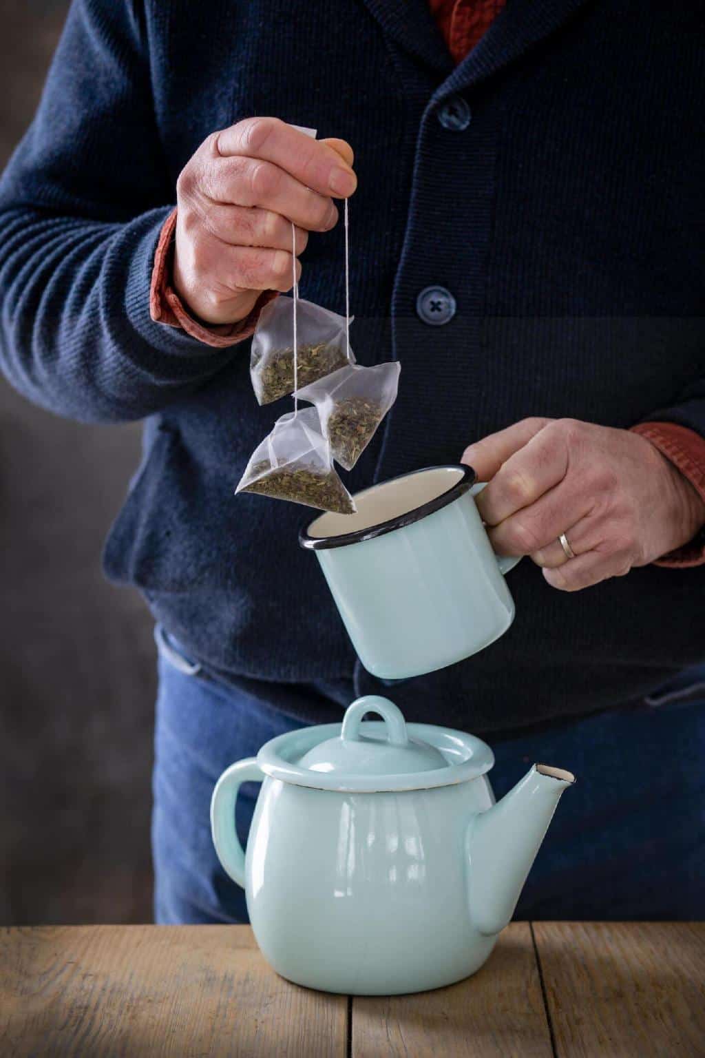 man making tea teapot teabags
