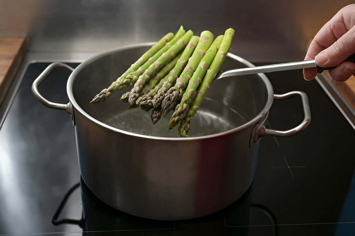 green asparagus on a skimmer in cooking