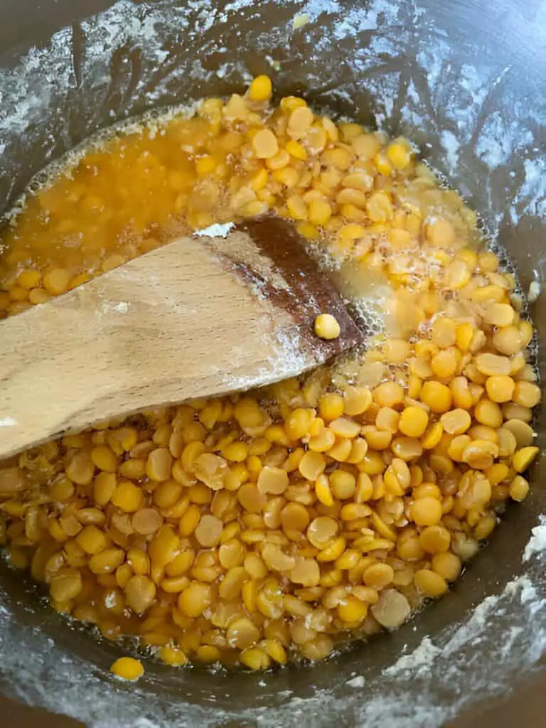 stirring yellow split peas and water boiling