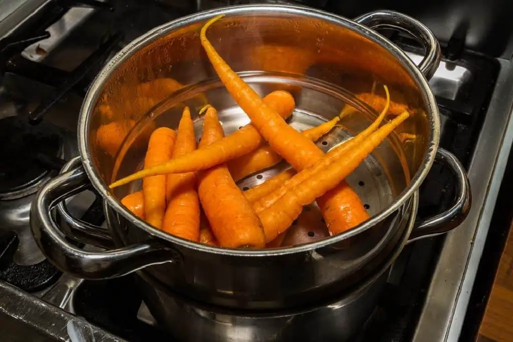 steaming carrots in a steamer