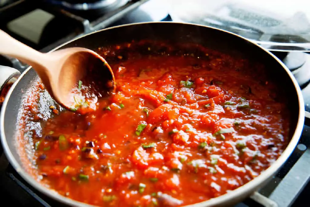 preparing fresh tomato sauce for spaghetti