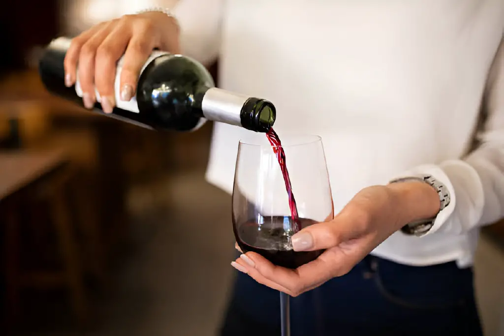 serving red wine in a winery