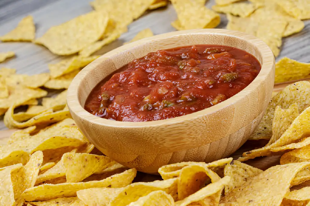 delicious bowl of roasted corn-tortilla-chips on wooden with salsa