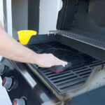 cleans the black grill with soft brush grill frying meat