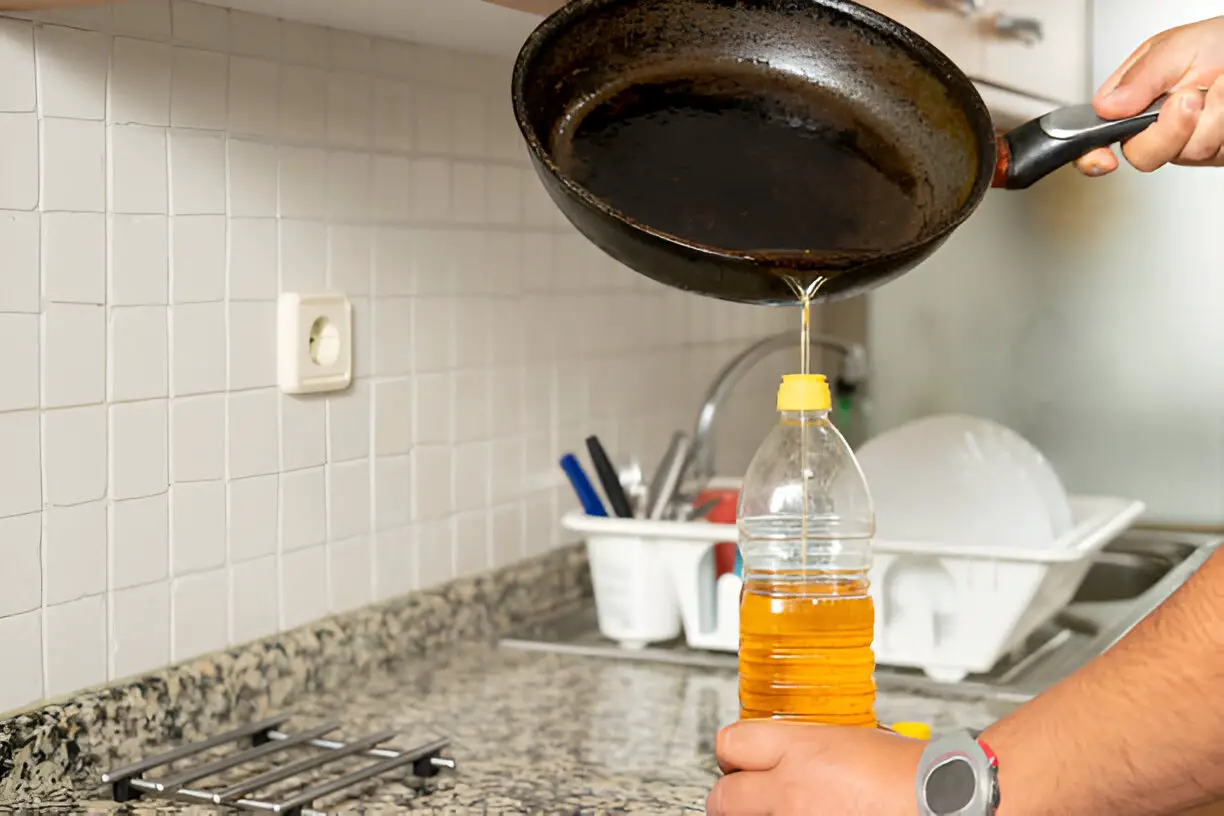 placing recycled edible oil from a frying pan