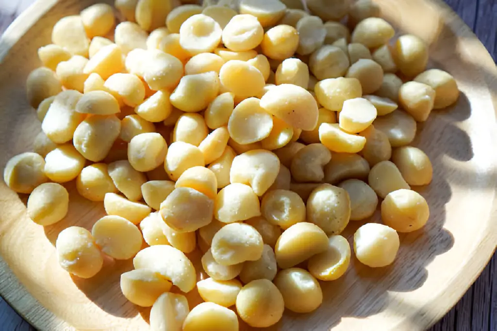 roasted macadamia on a wooden dinner plate