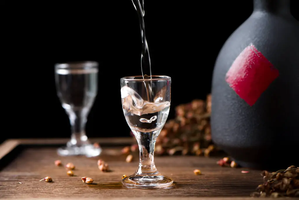 chinese liquor baijus pouring into a glass from a bottle