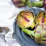 fresh big romanesco artichokes green purple flower heads ready to cook