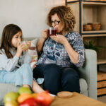 grandmother and granddaughter enjoy tea