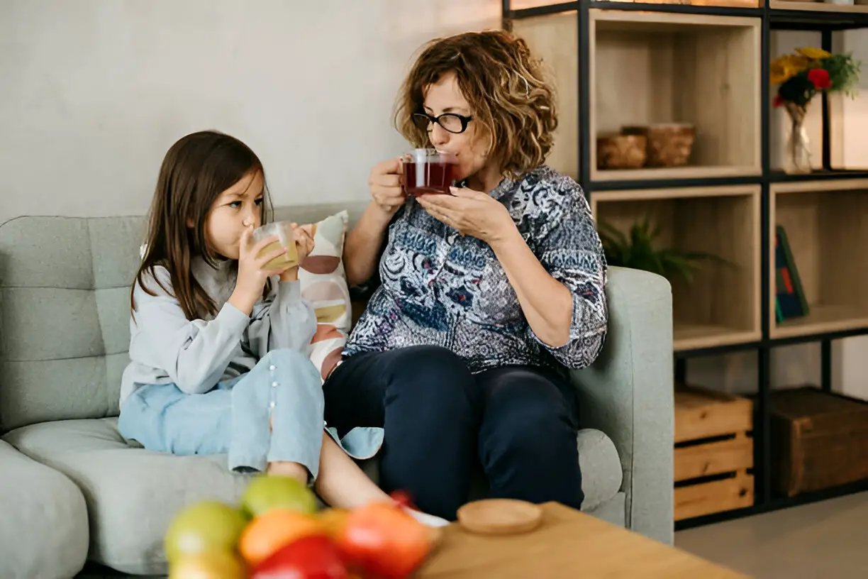 grandmother and granddaughter enjoy tea