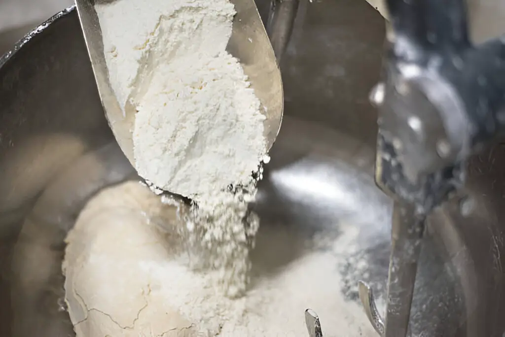 loading flour into an industrial dough mixer