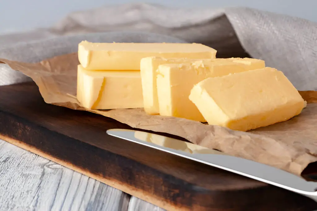 cut butter on plate with blue towel