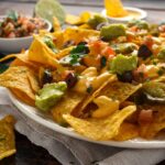 mexican nachos tortilla chips with olives jalapeno guacamole tomatoes salsa cheese