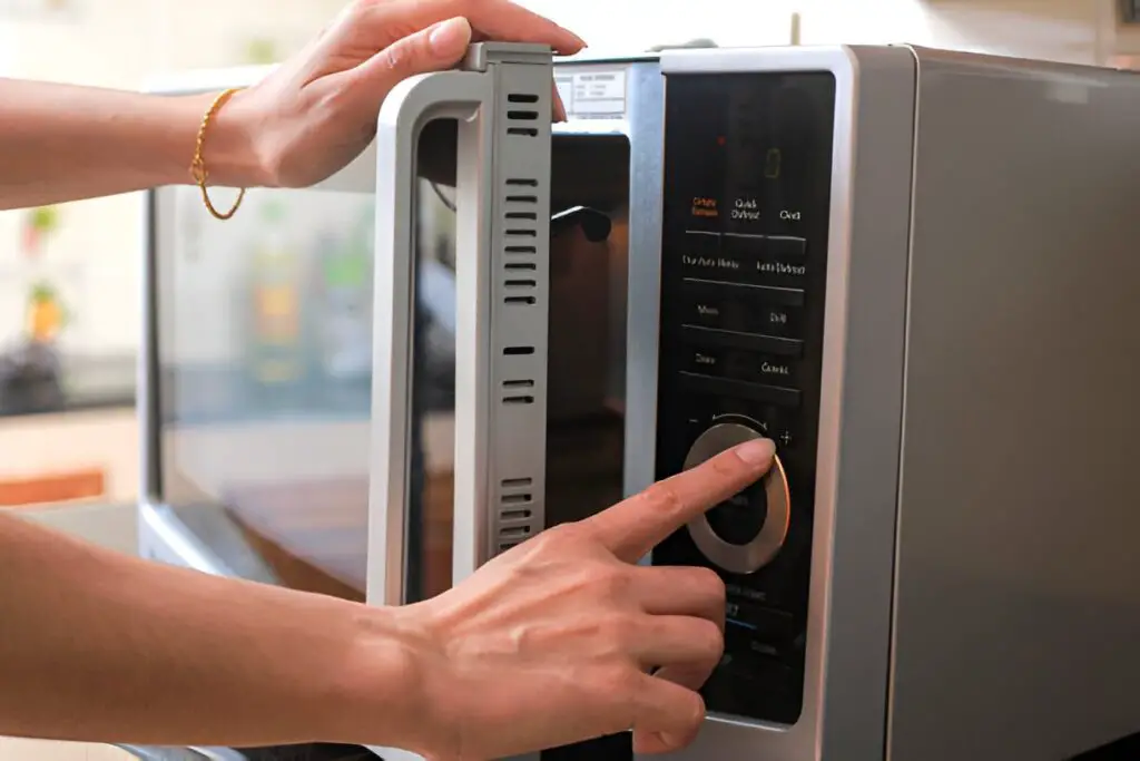 microwave oven door and preparing food in microwave