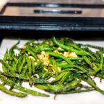 dehydrator black tray sheets with dehydrated vegetables green beans and garlic