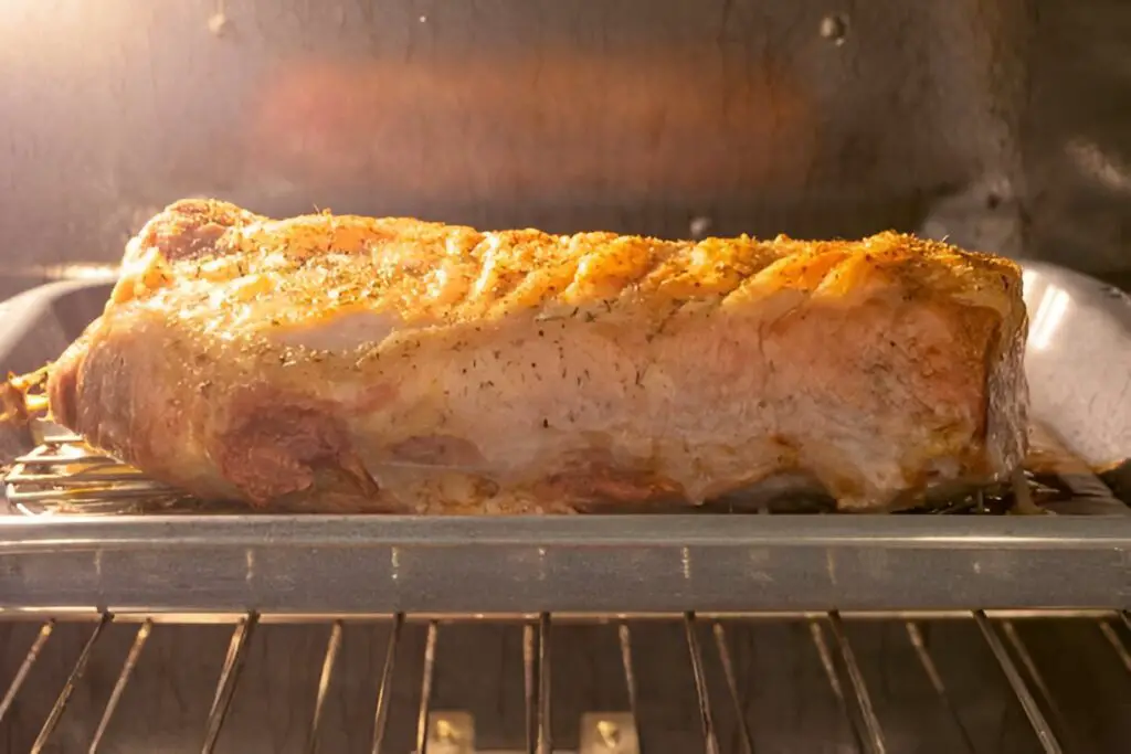 fresh pork loin roast cooked seasoned out of the oven
