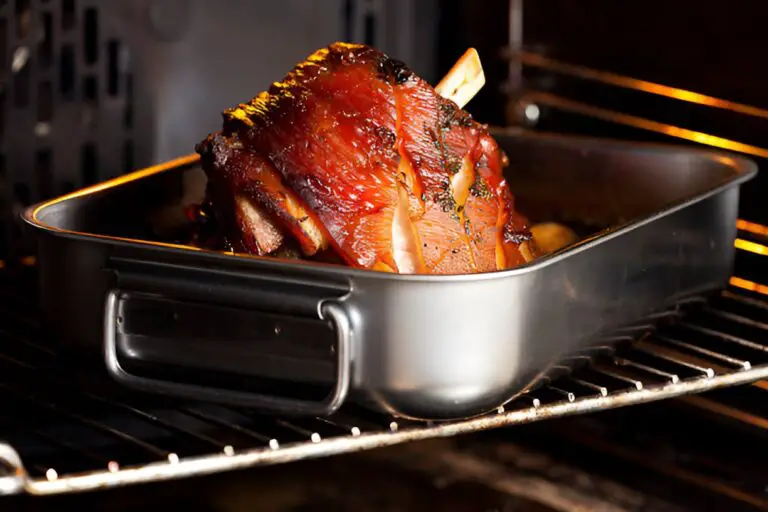 knuckle of pork in roasting tin in oven