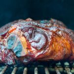 pork shoulder getting smoked for pulled pork