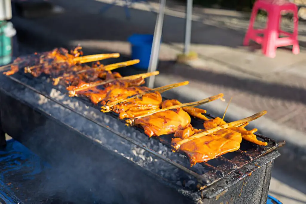 many pieces of rubber chicken on a charcoal grill