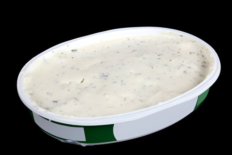 oval open plastic box with soft cheese with garlic and dill isolated