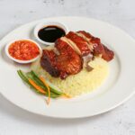 roasted chicken rice with chilli and soy sauce served in dish