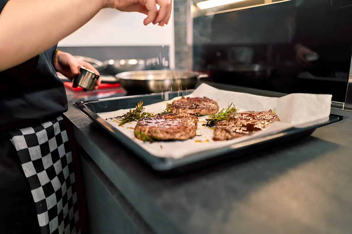 steak is cooking on the stove to oven