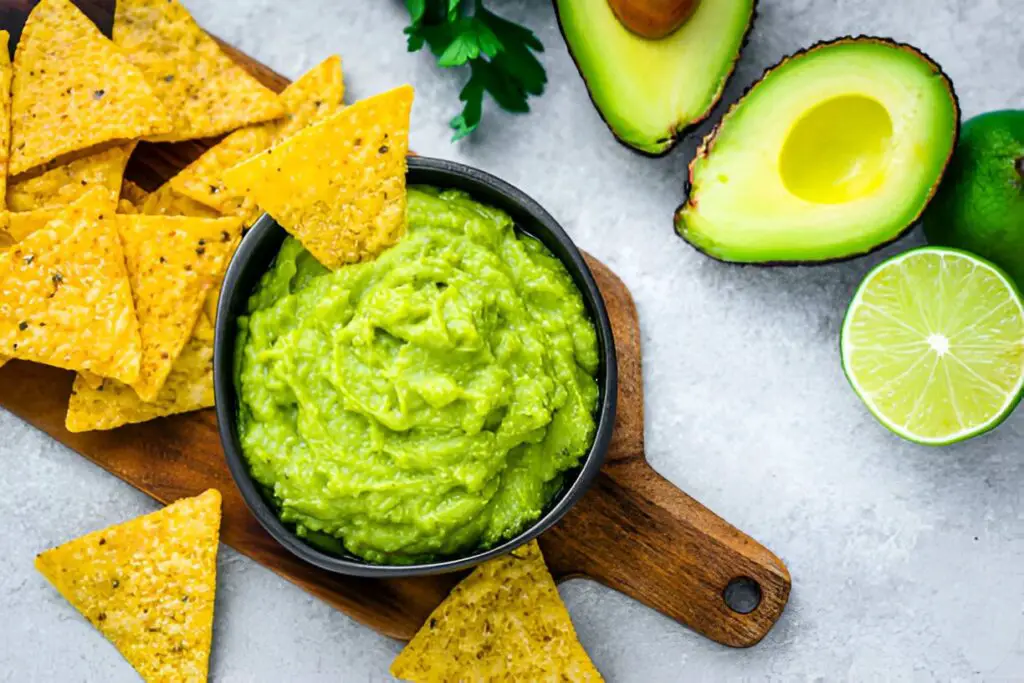 guacamole and nachos shot from above on gray table