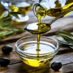 pouring extra virgin olive oil in a glass bowl